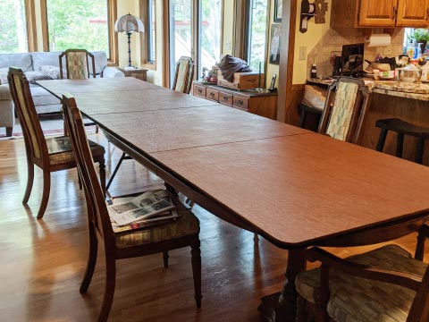 Photo: two tables extended into one long table using a cherry woodgrain extender